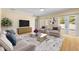 Bright living room with modern furnishings, a large rug, and access to the outdoor patio at 4515 W Leona St, Tampa, FL 33629