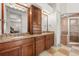 The main bathroom has granite countertops, dual sinks, and a glass enclosed shower at 4515 W Leona St, Tampa, FL 33629