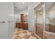 Main bathroom has a tiled shower, dual sink vanity, and large mirror at 4515 W Leona St, Tampa, FL 33629