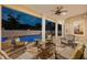 The covered outdoor living area includes comfortable seating and views of the in-ground pool and private yard at 4515 W Leona St, Tampa, FL 33629