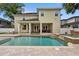 Back of house featuring a large pool, spa, waterfall, patio, and white pillars at 4515 W Leona St, Tampa, FL 33629