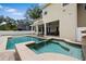 Beautiful backyard with a large pool, spa, waterfall, and a covered patio with outdoor seating at 4515 W Leona St, Tampa, FL 33629