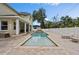 A view of the pool, spa, and the home's backyard featuring a white fence at 4515 W Leona St, Tampa, FL 33629