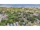 An aerial view showcasing a quiet residential neighborhood with lush trees and a glimpse of the waterfront at 526 5Th N Ave, Safety Harbor, FL 34695