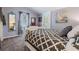 Bedroom with neutral walls, plush carpet, comfortable bed, mirror, and exit to the exterior at 526 5Th N Ave, Safety Harbor, FL 34695