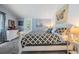 Bright bedroom features neutral walls, plush carpet, and a comfortable bed with decorative pillows at 526 5Th N Ave, Safety Harbor, FL 34695