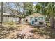 Charming home with a well-manicured lawn, picket fence, and brick walkway at 526 5Th N Ave, Safety Harbor, FL 34695