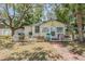 Charming single-story home featuring a brick path, white picket fence, and ample foliage at 526 5Th N Ave, Safety Harbor, FL 34695