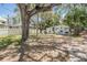 Charming home with a white picket fence and mature trees, creating a cozy and inviting curb appeal at 526 5Th N Ave, Safety Harbor, FL 34695