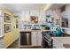 Cozy kitchen with white cabinets, stainless steel appliances, and colorful tile backsplash at 526 5Th N Ave, Safety Harbor, FL 34695