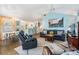 Cozy living room open to the dining area with comfortable seating, artwork, and a ceiling fan at 526 5Th N Ave, Safety Harbor, FL 34695