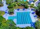 Aerial view of community pool and lounge area with blue umbrellas for shade near lush landscaping at 6030 Sandhill Ridge Dr, Lithia, FL 33547