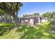 Expansive backyard featuring screened patios, lush landscaping, and mature trees for ultimate privacy at 6030 Sandhill Ridge Dr, Lithia, FL 33547