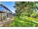 Scenic backyard with screened-in lanai, lush lawn, and waterfront views offers a relaxing outdoor experience at 6030 Sandhill Ridge Dr, Lithia, FL 33547