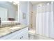 Bright bathroom featuring granite vanity, brushed nickel faucet, and a shower with a white shower curtain at 6030 Sandhill Ridge Dr, Lithia, FL 33547