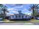 Stunning community center with manicured landscaping, palm trees, and aquatic club amenities at 6030 Sandhill Ridge Dr, Lithia, FL 33547