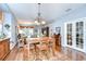 Cozy dining area featuring a wooden table, chandelier, and seamlessly flowing into the inviting living room at 6030 Sandhill Ridge Dr, Lithia, FL 33547