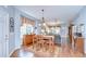Open-concept dining area with a hardwood floor, natural lighting, and a view into the living room at 6030 Sandhill Ridge Dr, Lithia, FL 33547