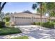Charming home with a three-car garage, well-manicured landscaping, and a spacious driveway at 6030 Sandhill Ridge Dr, Lithia, FL 33547