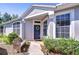 Inviting entryway with a decorative wreath on the front door and a cozy bench at 6030 Sandhill Ridge Dr, Lithia, FL 33547