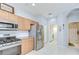 Functional kitchen with gas range, stainless steel appliances, and access to laundry room at 6030 Sandhill Ridge Dr, Lithia, FL 33547