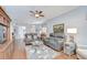Bright living room with hardwood floors, two leather sofas, and stylish glass coffee table with decorative rug at 6030 Sandhill Ridge Dr, Lithia, FL 33547