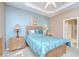Relaxing main bedroom featuring light wood furniture, a tray ceiling and a doorway to ensuite bathroom at 6030 Sandhill Ridge Dr, Lithia, FL 33547