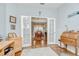 Cozy office with French doors leading to the dining room with a hardwood floor and desk at 6030 Sandhill Ridge Dr, Lithia, FL 33547