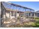 Screened-in lanai featuring patio furniture and grill, creating the perfect outdoor dining experience at 6030 Sandhill Ridge Dr, Lithia, FL 33547