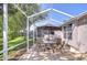 Screened-in lanai featuring patio dining set and umbrella, perfect for outdoor relaxation and entertaining at 6030 Sandhill Ridge Dr, Lithia, FL 33547