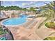 Resort-style pool featuring a rock waterfall, lounge chairs, and lush landscaping for ultimate relaxation at 6030 Sandhill Ridge Dr, Lithia, FL 33547