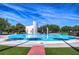 Community splash pad area with a modern architectural element and lush landscaping at 6030 Sandhill Ridge Dr, Lithia, FL 33547