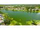 A picturesque view of a lakefront community, complete with lush trees and manicured lawns at 6705 Ranger Dr, Tampa, FL 33615