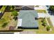 Aerial view of a residential property with a shingled roof and a compact, well kept backyard at 6705 Ranger Dr, Tampa, FL 33615
