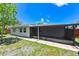 Backyard view showcasing the screened in patio, lush lawn, and mature landscaping at 6705 Ranger Dr, Tampa, FL 33615