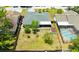Aerial view of a large fenced backyard with green grass, mature trees, and a storage shed at 6705 Ranger Dr, Tampa, FL 33615