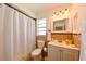 Bathroom featuring a white vanity, decorative mirror and a shower/tub with white shower curtain at 6705 Ranger Dr, Tampa, FL 33615