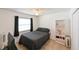 Cozy bedroom featuring neutral walls, tile flooring, ceiling fan and a comfortable double bed at 6705 Ranger Dr, Tampa, FL 33615