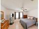Cozy bedroom with tiled floors, two large windows, and a ceiling fan at 6705 Ranger Dr, Tampa, FL 33615