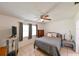 Bedroom featuring tiled floors, two large windows, and a ceiling fan at 6705 Ranger Dr, Tampa, FL 33615