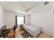Bedroom with desk and neutral-toned walls and tile flooring at 6705 Ranger Dr, Tampa, FL 33615