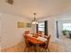 Bright dining area features tile floors and a large oval wooden table with seating for four at 6705 Ranger Dr, Tampa, FL 33615