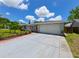 Home featuring a two-car garage and a large driveway surrounded by well-kept landscaping at 6705 Ranger Dr, Tampa, FL 33615