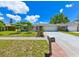 Well-manicured front lawn and landscaped garden of a single-story home with a two-car garage at 6705 Ranger Dr, Tampa, FL 33615