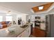 Open kitchen view with granite countertops, stainless appliances and adjacent living space at 6705 Ranger Dr, Tampa, FL 33615