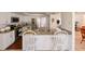 Modern kitchen with stainless steel appliances, granite counters, and eat-in breakfast bar with white chairs at 6705 Ranger Dr, Tampa, FL 33615