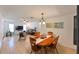 Inviting living space with tiled floors that flows into a dining area with an oval table at 6705 Ranger Dr, Tampa, FL 33615