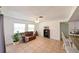 Bright living room with tile floors, a comfortable sofa, and natural light near the kitchen at 6705 Ranger Dr, Tampa, FL 33615