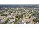 Aerial view of a residential area showcasing homes and streets interspersed with trees and foliage at 7111 Oregon Chickadee Rd, Weeki Wachee, FL 34613