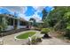 Backyard view featuring an in-ground pool, the house, gazebo, and some trees at 7111 Oregon Chickadee Rd, Weeki Wachee, FL 34613